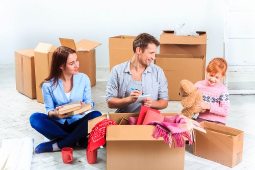 Careful loading of household items during removals in a typical Ilford street