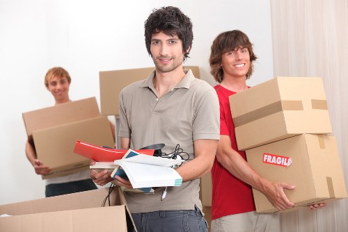 Packed household boxes and furniture prepared for a move from an Ilford home